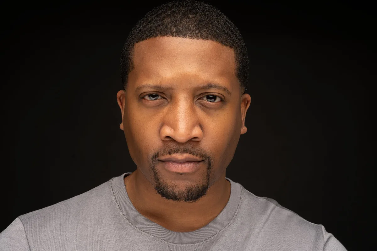 Jae Anderson headshot — grey crew neck, direct to camera