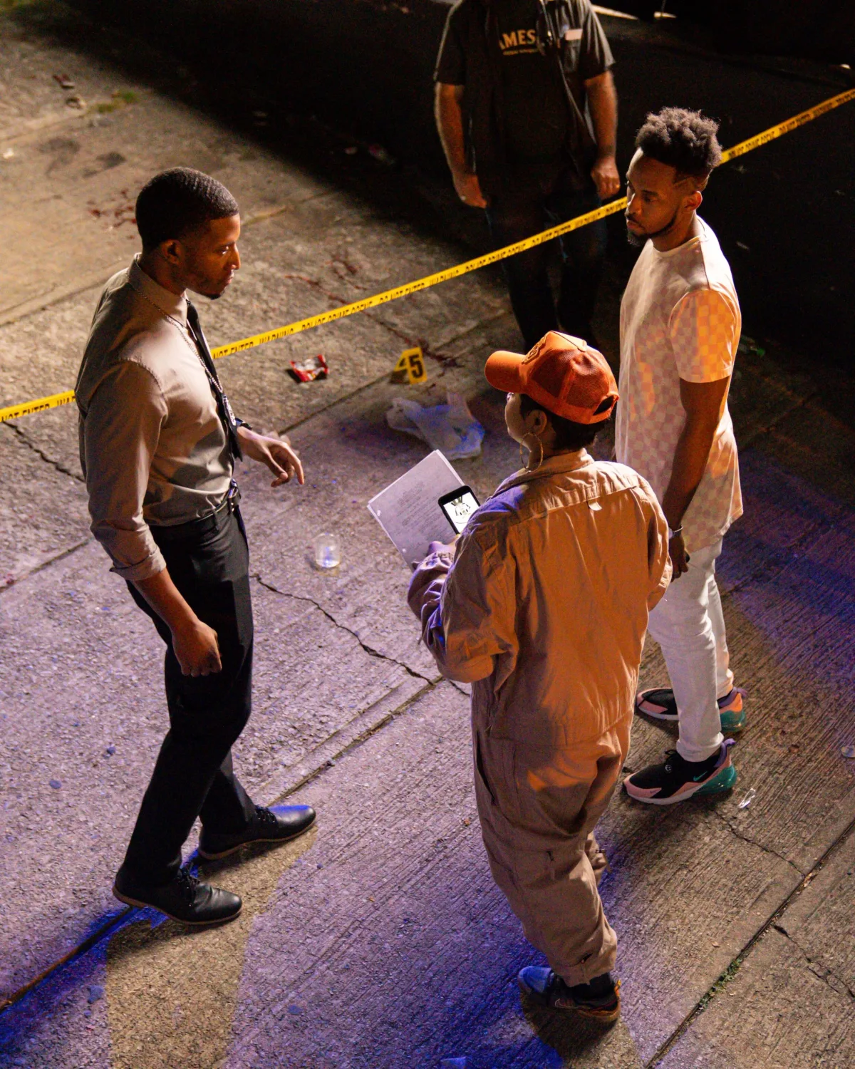 Jae approaching a crime scene on set