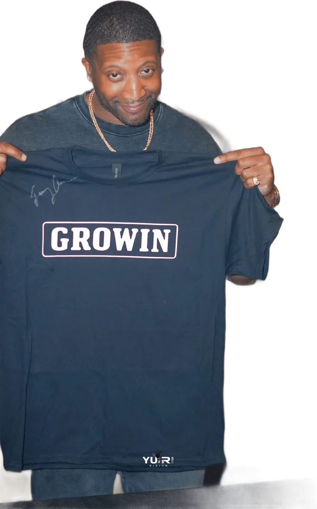 Jae holding up a GROWIN shirt