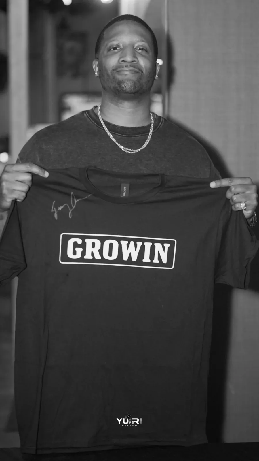 Jae holding the original black GROWIN shirt